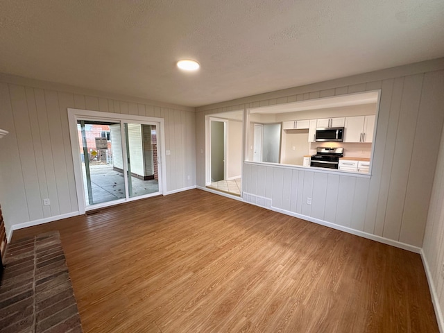 unfurnished living room featuring hardwood / wood-style flooring