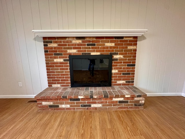 interior details featuring a fireplace and hardwood / wood-style flooring