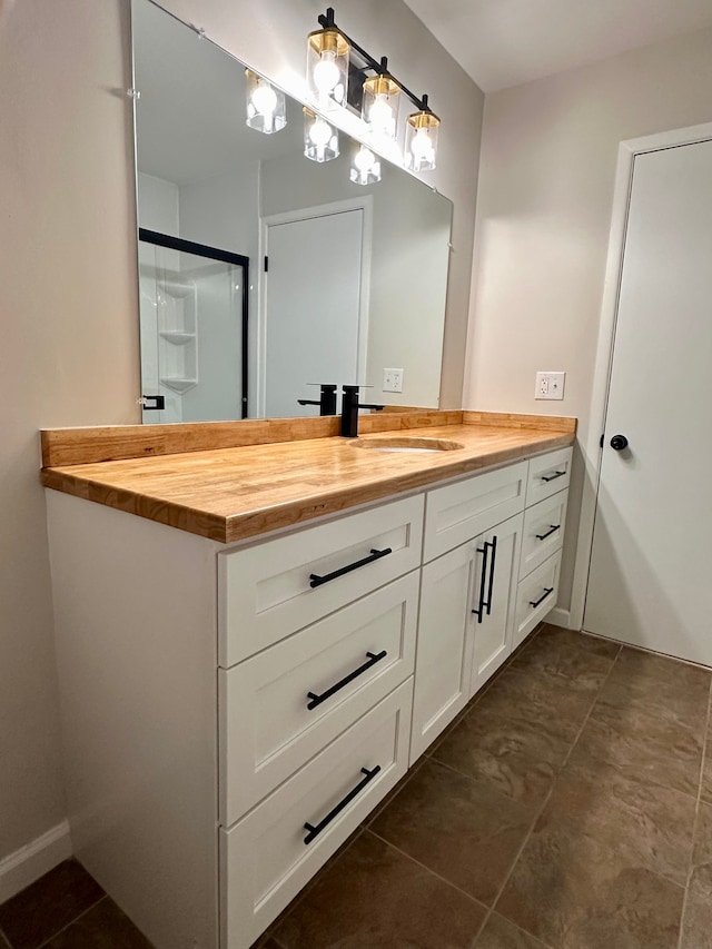 bathroom featuring vanity and a shower with door