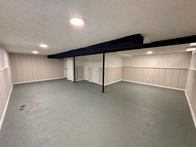 basement featuring a textured ceiling