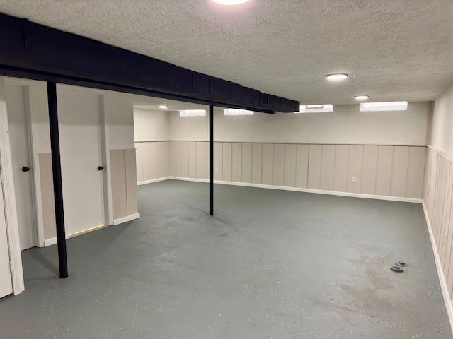 basement featuring a textured ceiling