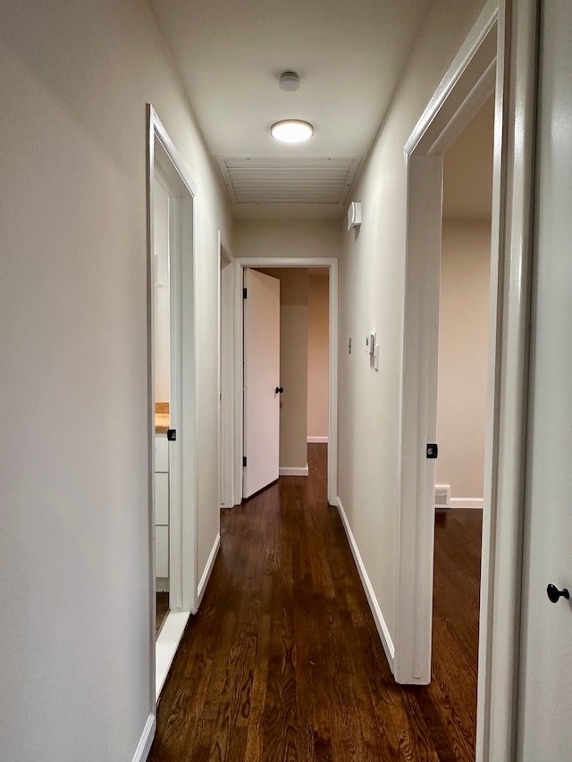 corridor with dark hardwood / wood-style floors