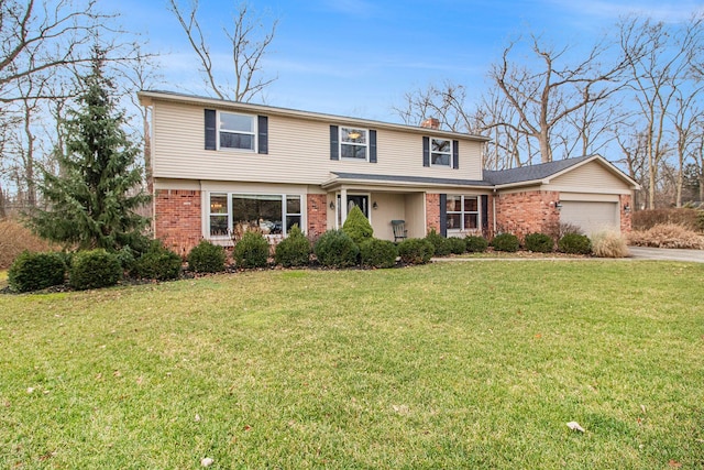 view of property featuring a garage and a front lawn