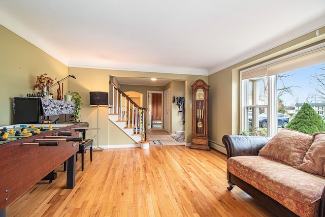 living room with a baseboard radiator and light wood-type flooring