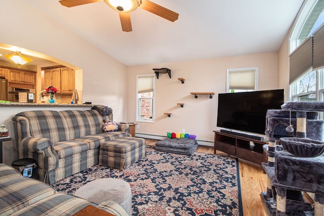 living room with light hardwood / wood-style floors, a baseboard radiator, ceiling fan, and lofted ceiling