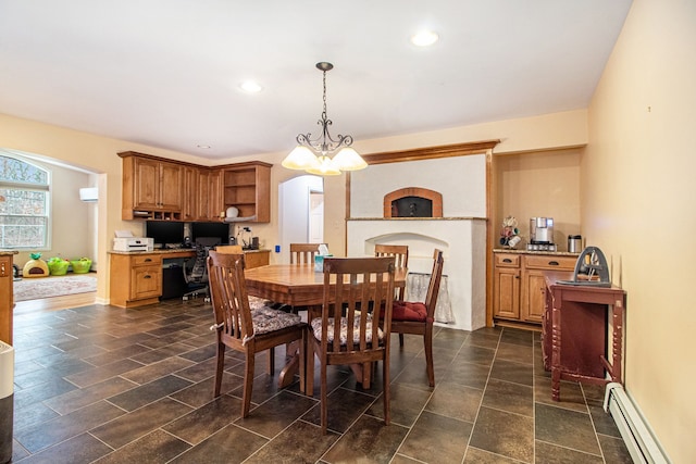 dining area with a baseboard radiator and a notable chandelier