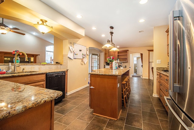 kitchen featuring stainless steel fridge, a center island, sink, decorative light fixtures, and black dishwasher