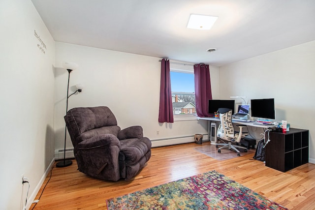 office space with wood-type flooring and baseboard heating