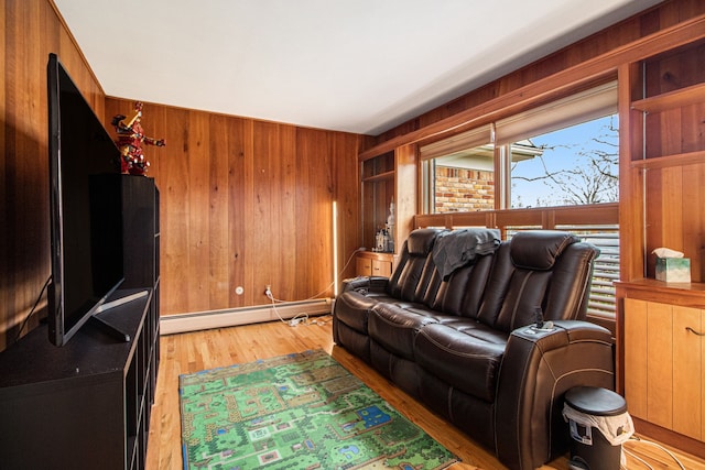 living room with wood walls, light hardwood / wood-style flooring, and a baseboard radiator