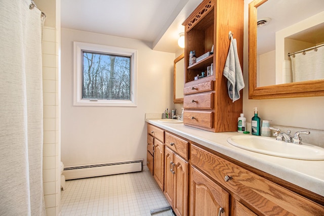 bathroom with vanity and a baseboard radiator