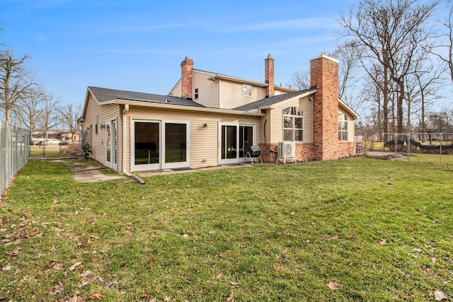 rear view of house with a yard