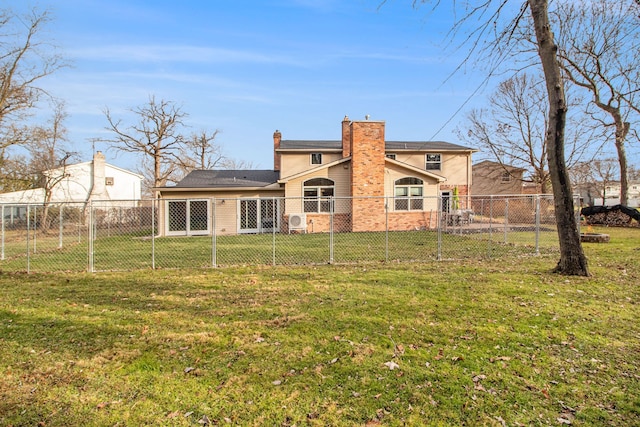 rear view of property with a yard