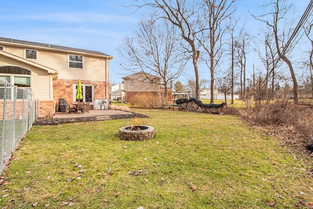 view of yard with an outdoor fire pit and a patio area