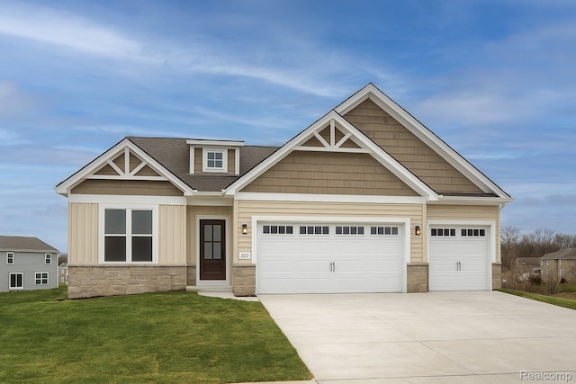 MOH44 Birkdale Dr, Howell, MI 48843 - craftsman-style house with stone siding, concrete driveway, a front lawn, board and batten siding, and a garage
