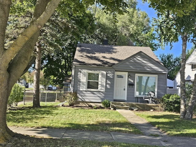 bungalow-style house with a front yard