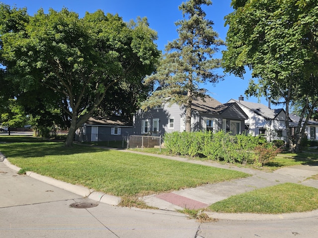 obstructed view of property with a front yard