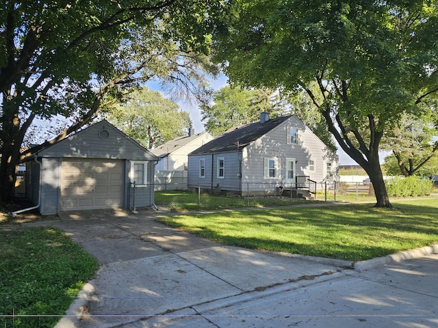 view of front of property featuring a front yard, an outdoor structure, and a garage