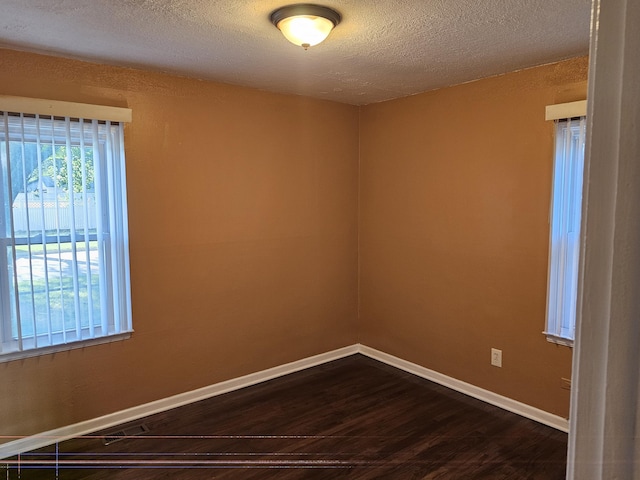 empty room featuring hardwood / wood-style floors and a textured ceiling