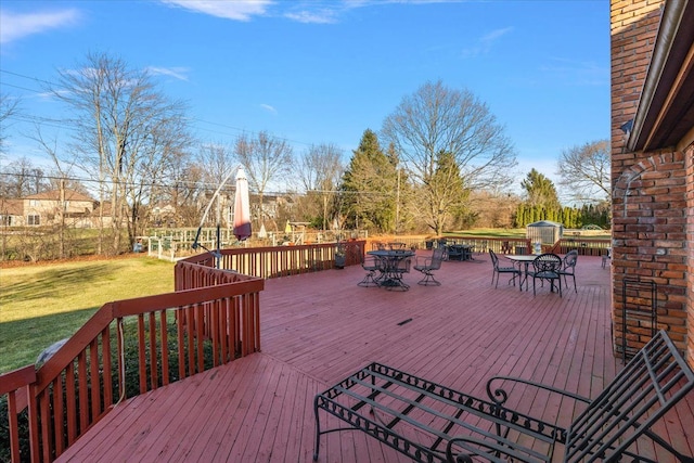 wooden terrace with a yard