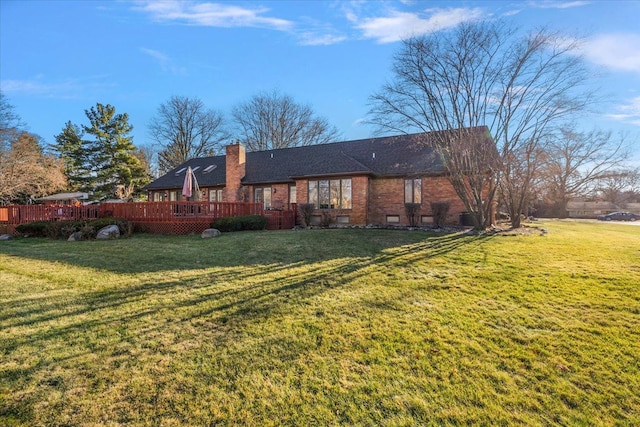 back of house with a lawn and a wooden deck