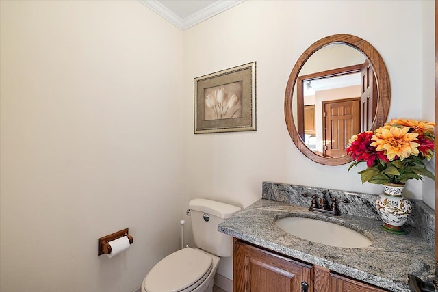 bathroom featuring vanity, toilet, and ornamental molding