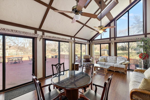 sunroom featuring vaulted ceiling, ceiling fan, and a healthy amount of sunlight