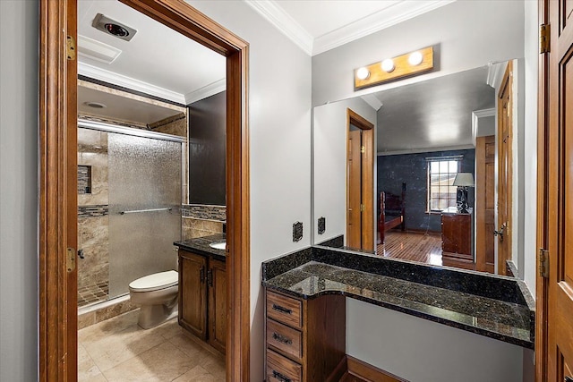 bathroom featuring vanity, crown molding, tile patterned flooring, toilet, and walk in shower