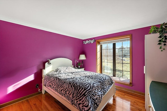 bedroom featuring multiple windows, ornamental molding, and hardwood / wood-style flooring