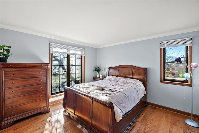 bedroom with crown molding and light wood-type flooring