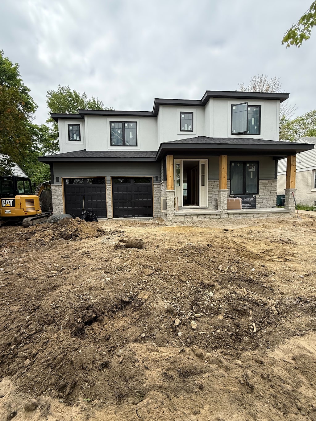 1978 Henrietta St, Birmingham, MI 48009 - view of front facade with covered porch, an attached garage, stone siding, and stucco siding