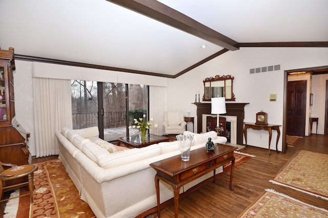 living room featuring ornamental molding, wood-type flooring, and lofted ceiling with beams