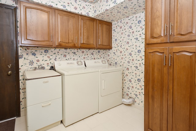 laundry area featuring cabinets and washer and clothes dryer