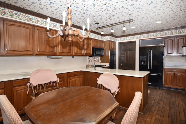 kitchen featuring sink, crown molding, dark wood-type flooring, and black appliances