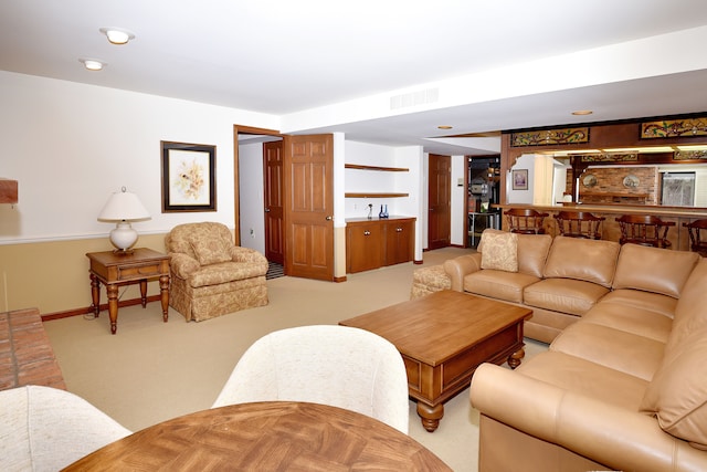 living room featuring light carpet and bar area