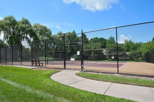 view of tennis court with a lawn