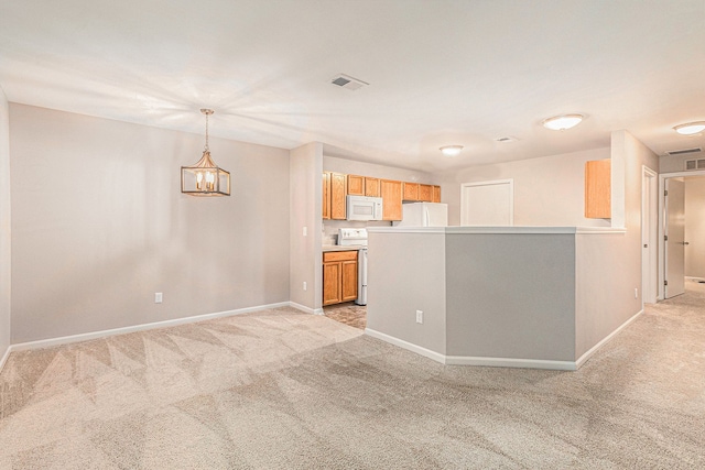 interior space featuring light colored carpet, white appliances, hanging light fixtures, and a chandelier