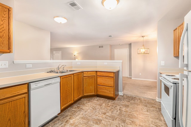 kitchen with white appliances, sink, hanging light fixtures, light colored carpet, and kitchen peninsula