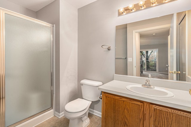 bathroom featuring tile patterned flooring, vanity, toilet, and an enclosed shower