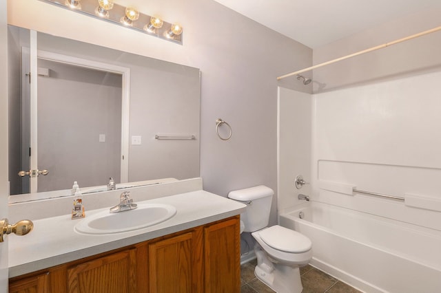 full bathroom featuring washtub / shower combination, tile patterned flooring, vanity, and toilet