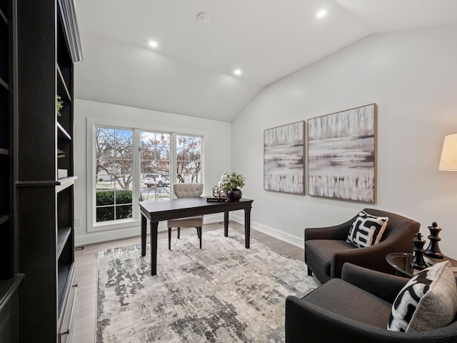 office space with light hardwood / wood-style flooring and lofted ceiling