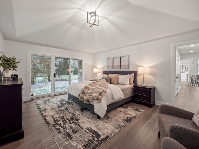 bedroom with access to exterior, dark hardwood / wood-style floors, and a notable chandelier