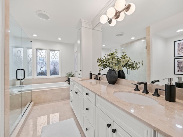 bathroom featuring vanity and independent shower and bath