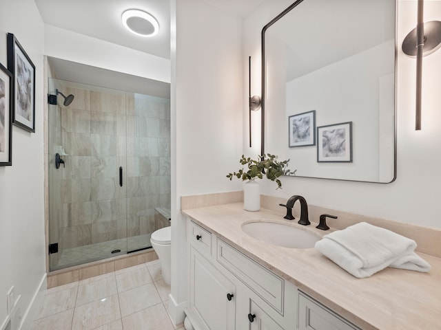 bathroom featuring tile patterned flooring, vanity, a shower with shower door, and toilet