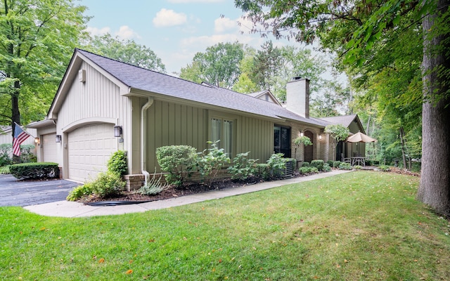 view of home's exterior with a yard and a garage