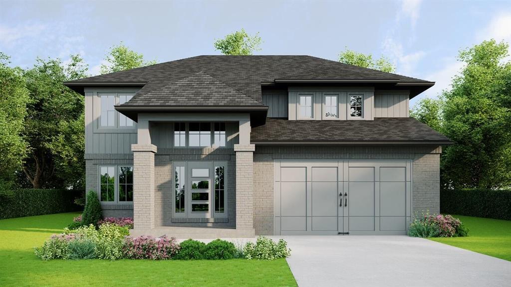 view of front of house with a garage and a front lawn