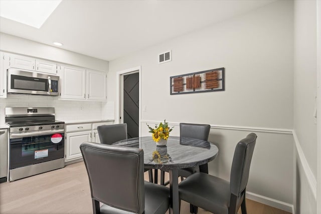 dining space with light wood-type flooring