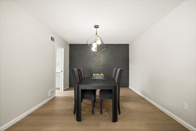 dining area with wood-type flooring