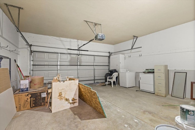 garage with washer / dryer and a garage door opener