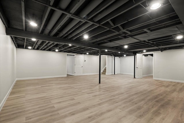 basement with hardwood / wood-style floors