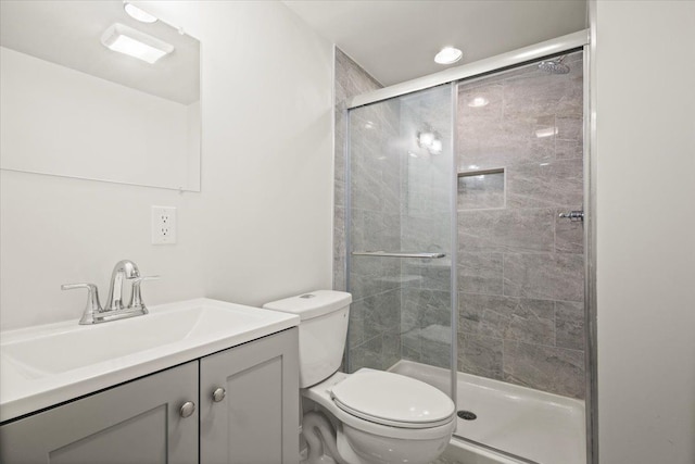 bathroom with vanity, toilet, and walk in shower